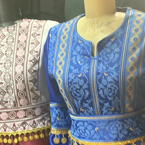 Blue and pink tatreez dresses with gold coin trim in Amman