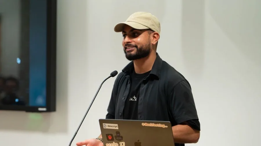 Furquan speaking at the lectern at AI Tinkerers Doha